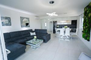 a living room with a blue couch and a table at Crystal Adria in Privlaka