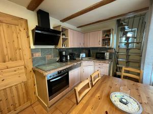 a kitchen with a table and a stove top oven at Ferienhaus Fichtelberg in Kurort Oberwiesenthal