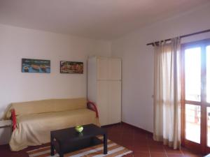 a living room with a couch and a window at Residence La Bricola Sestante 26 in I Casoni