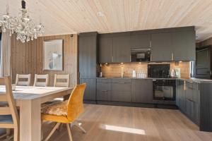a kitchen with a table and a dining room at Trysil turistesenter hytte in Trysil