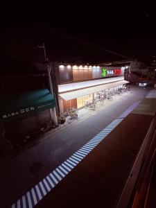 a building with bikes parked in front of it at night at hostel sunflower202 in Osaka