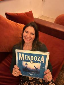 a woman holding a sign that reads merida at MENDOZA Suites 3 -Parking disponible- in Mendoza +37 photos