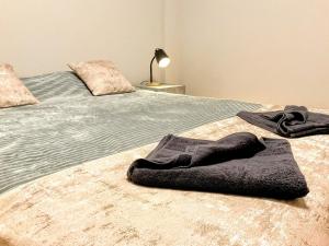 a bedroom with a bed with a blanket on it at Casa Pinheiro in Pinheiro de Coja