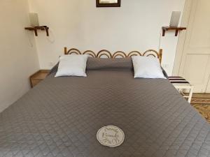 a large bed in a bedroom with a gray bedspread at Casa in Piazza in Fondi