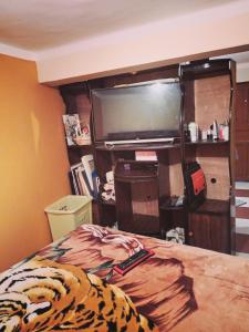 a bedroom with a bed with a television and remote controls at Aparment equipped and independent in La Paz