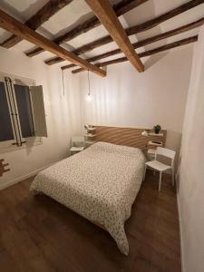 a bedroom with a bed and a table and a chair at Le Casette di Elen in Marsala