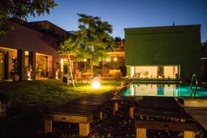 a house with a swimming pool in the yard at Refugio Padma in Chacras de Coria