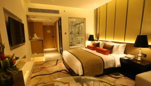 a hotel room with a bed and a table at Pride Plaza Hotel, Aerocity New Delhi in New Delhi