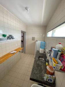 a kitchen with a sink and a refrigerator at Flat Barra Beach in Barra de São Miguel