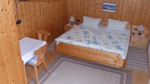 a bedroom with a bed and a chair in it at Lucknerhof in Kals am Großglockner