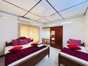 ジャフナにあるYaarl Holidayのベッドルーム1室(赤い枕のベッド2台付) +17枚の写真