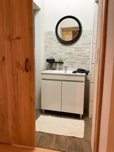 a bathroom with a white sink and a mirror at Casa Pinheiro in Pinheiro de Coja