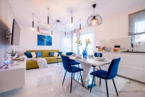 a kitchen and living room with a table and chairs at White Rose Hill Luxury Apartment Budapest in Budapest