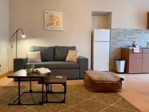 a living room with a couch and a table and a refrigerator at Casa Pinheiro in Pinheiro de Coja +8 photos