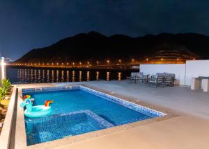 a swimming pool with a rubber duck in a toy in the water at Al Dana Vitamin Sea Villa in Fujairah