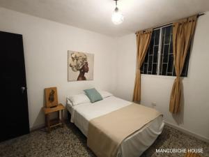Postel nebo postele na pokoji v ubytování MANGO BiCHE - HOUSE