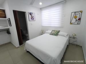 Postel nebo postele na pokoji v ubytování MANGO BiCHE - HOUSE