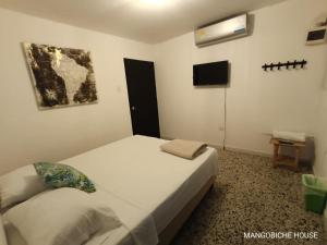 Postel nebo postele na pokoji v ubytování MANGO BiCHE - HOUSE