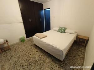 Postel nebo postele na pokoji v ubytování MANGO BiCHE - HOUSE