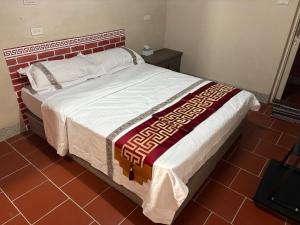 Postel nebo postele na pokoji v ubytování 隨心驛站古厝民宿 + 5 fotografií