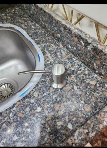 a sink with a stopper on a granite counter top at s5tar hotel rooms in front of Mansoura University in Mît Khamîs +21 photos