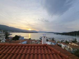 a view from the roof of a town with the water at Poros sunset house in Poros