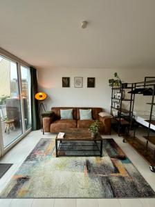 a living room with a couch and a table at Penthouse-Apartment am Schloss in Brühl