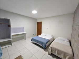 a bedroom with two beds in a room at Central House in Itajaí