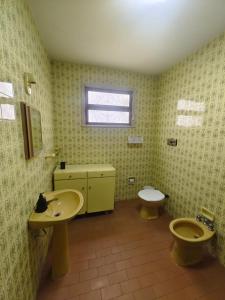 a bathroom with two sinks and a toilet at Central House in Itajaí +7 photos