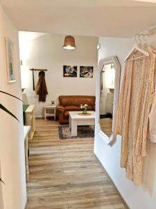 a living room with a couch and a mirror at Etela Old Town Apartment in Košice