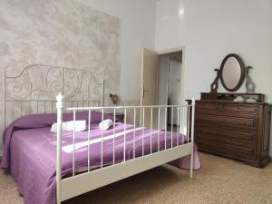 a bedroom with a bed and a dresser and a mirror at Holiday Home Camaiore near Lido Beaches in Camaiore +25 photos