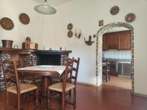 a kitchen with a table and chairs in a room at Holiday Home Camaiore near Lido Beaches in Camaiore