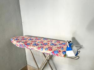 a chair with a floral sheet on it at Budget Rest House Padang Besar in Padang Besar