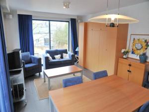 a living room with a table and chairs and a living room at Villa Apartment with Terrace in Durbuy