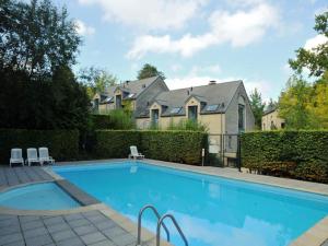 a large swimming pool in front of a house at Villa Apartment with Terrace in Durbuy +23 photos
