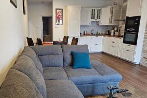 a living room with a couch and a kitchen at Apartments with a parking space Brdovec, Prigorje - 22481 in Prigorje Brdovečko