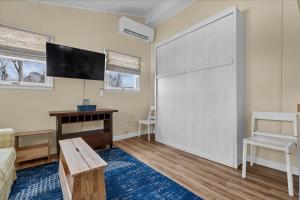 a living room with a large sliding door and a tv at Cozy apartment, private beach & jacuzzi in Westbrook