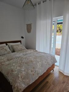 a bedroom with a large bed and a window at Seaside house for families with children Cove Nevidjansko Polje, Pasman - 24036 in Neviđane