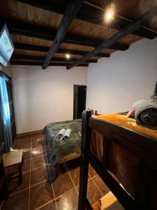 a bedroom with a bed and a chair in a room at Faustina in Purmamarca