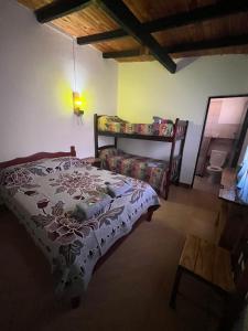 a bedroom with a bed and a couch and a table at Faustina in Purmamarca