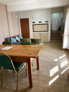 a living room with a table and a couch at Casa pura vida in General Roca
