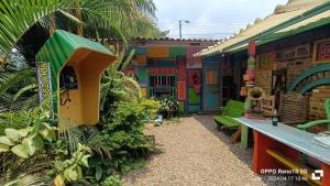a colorful house with a table and a bench at Hotel y Estadero Los Colores in Pajarito