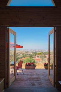 a patio with a chair and an open door at Chalet in San Pedro +6 photos