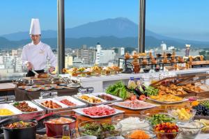 a chef standing in front of a buffet of food at Art Hotel Morioka in Morioka