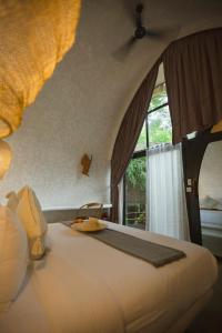 a bedroom with a large bed with a window at Panorama Boutique Hotel & Beach Club in El Nido +58 photos