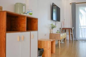 a kitchen with white cabinets and a wooden table at sunny islander diving resort in Looc