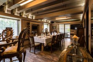 a dining room with a long table and chairs at Villa Vuchev in Velingrad