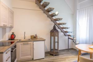 a kitchen with a spiral staircase in a room at Villa Vilielmini in Ioannina