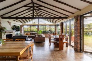 a living room with a wooden table and a fireplace at Country house with fireplace and mountain view in Ubaté