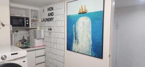 a kitchen with a painting on the wall at stay bnb 206 in Seoul +12 photos